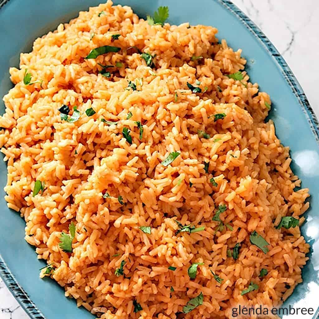 Mexican rice in a blue stoneware bowl.