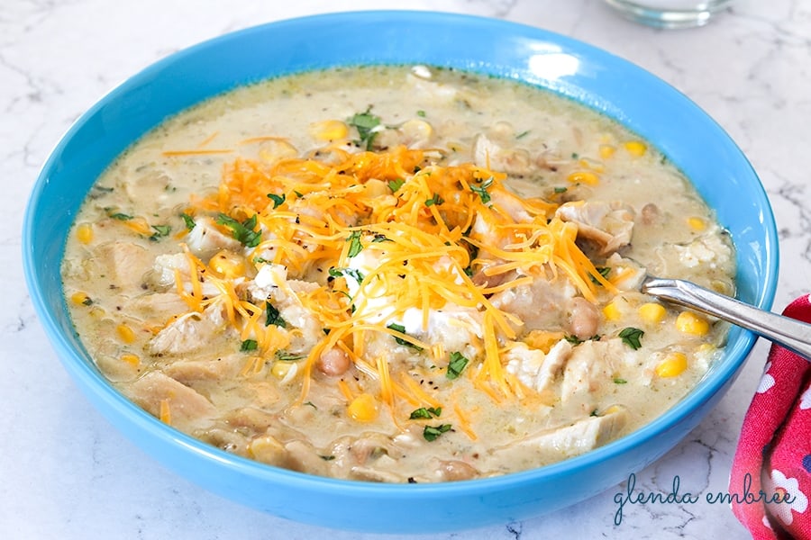 poblano chicken chili with sour cream, shredded cheddar and minced cilantro