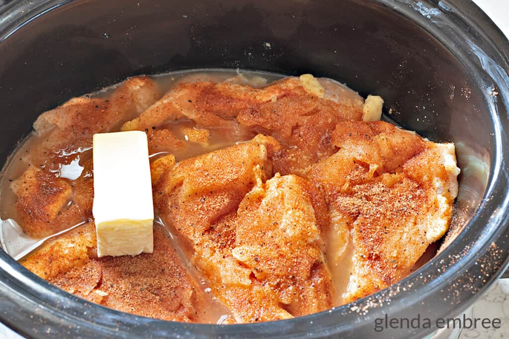 boneless skinless chicken breasts in crock pot seasoned with all purpose seasoning, butter and chicken stock