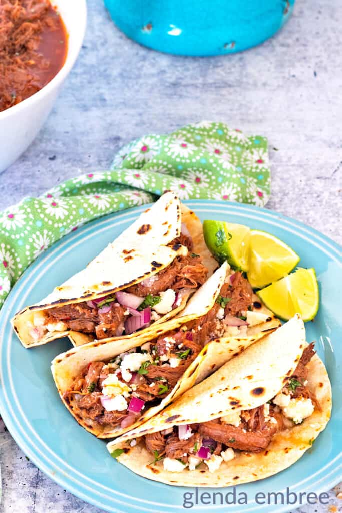 Mexican Street Tacos on a blue stoneware plate - shredded beef tacos