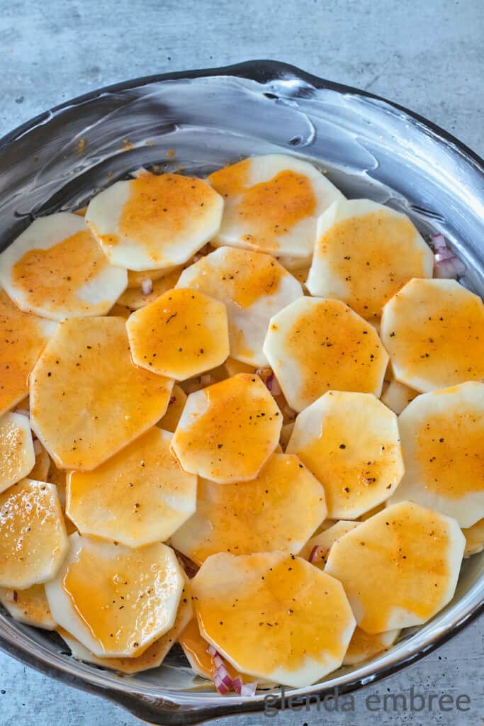 2nd layer of potatoes brushed with seasoned butter mixture
